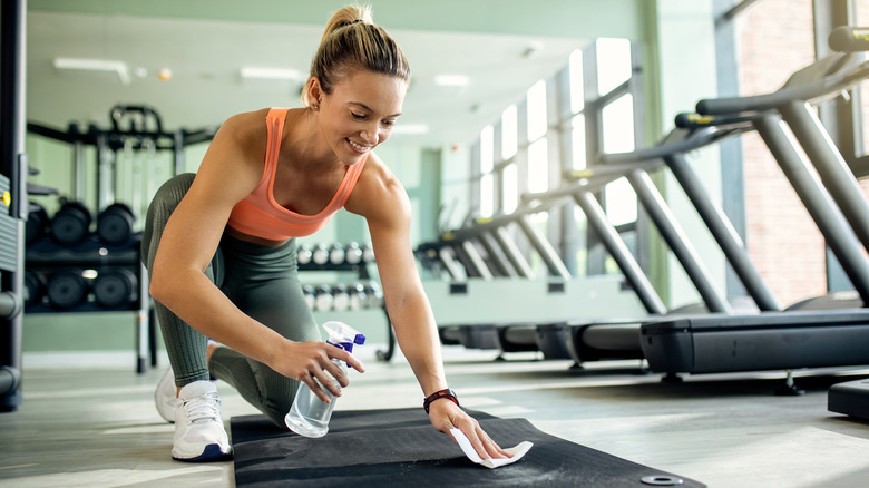 Woman cleaning yoga mat