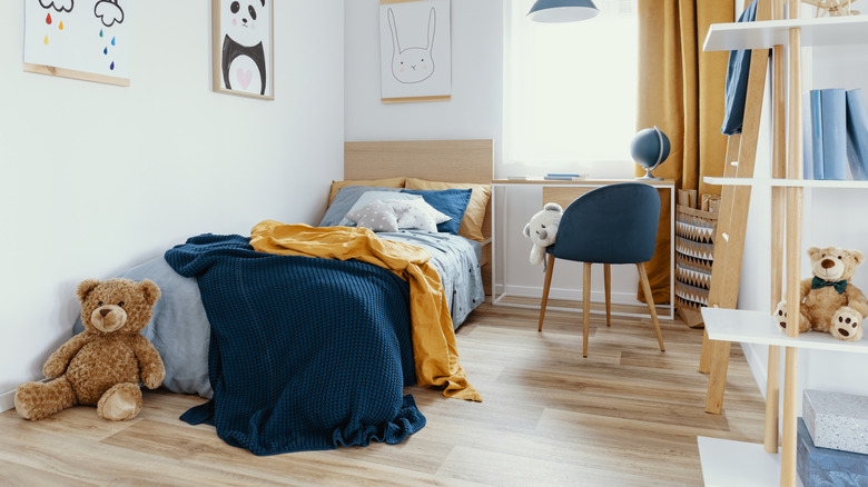 a child's bedroom with an untidy bed