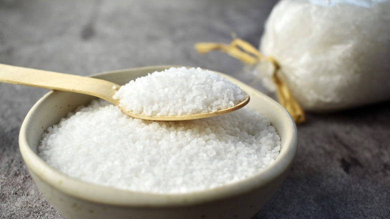 Spoon and bowl filled with coarse sea salt
