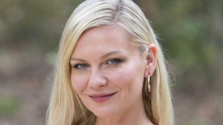 Kirsten Dunst smiles as she attends the Chanel Haute Couture Fall/Winter 2025/2026 show.