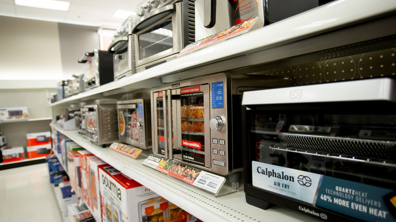 Variety of countertop cooking ovens on a store shelf