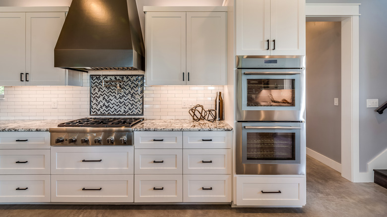 Built-in double ovens in a white kitchen