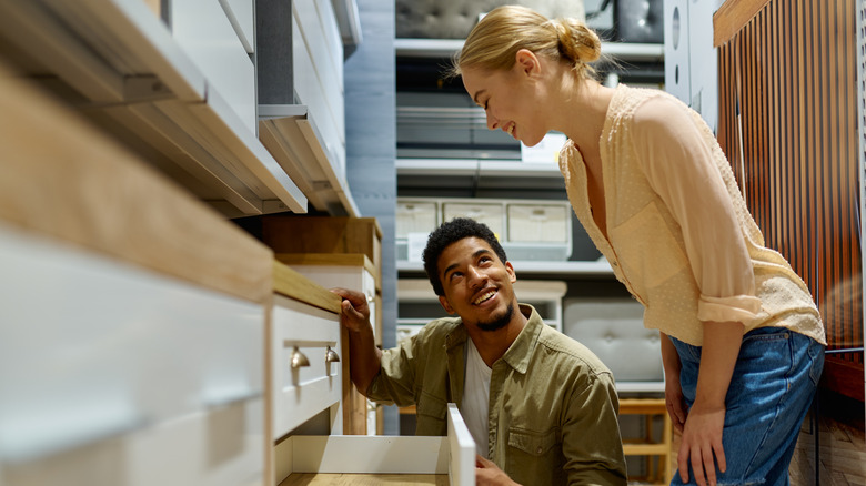 Couple selecting kitchen cabinets