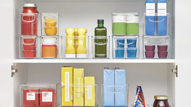 Pantry cupboard shelves organized with iDesign's Kitchen and Pantry Storage Bins