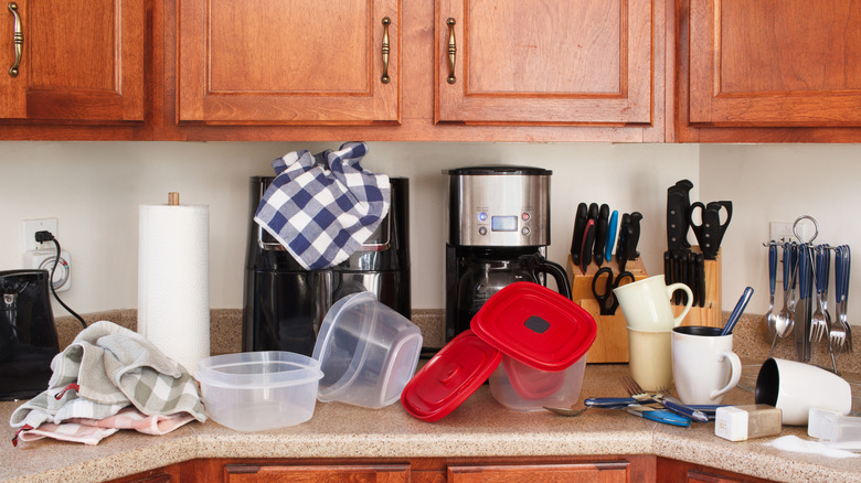 A heavily cluttered kitchen counter