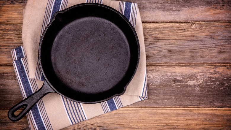 cast iron pan resting on a linen kitchen towel