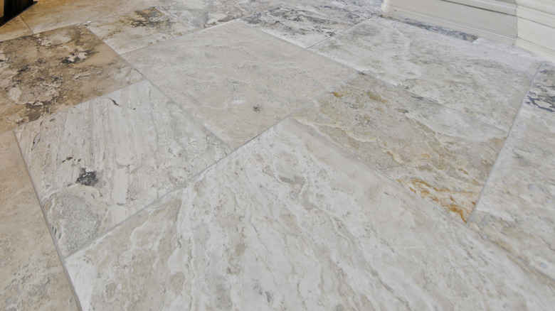A close up on a limestone tile floor.