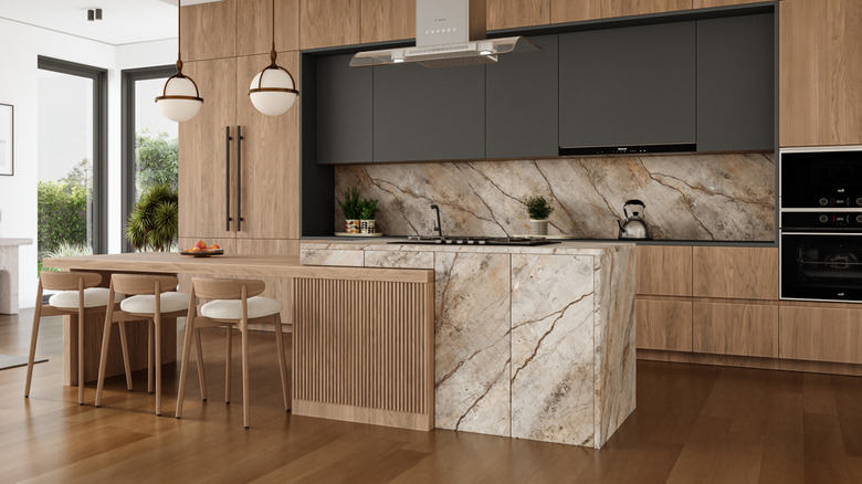 A neutral kitchen with wood floors and cabinetry.