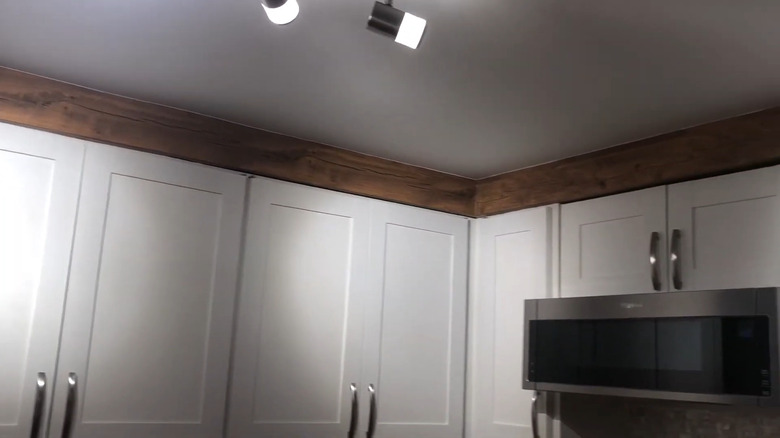 wood wallpaper or contact paper on a soffit looks like wood beams