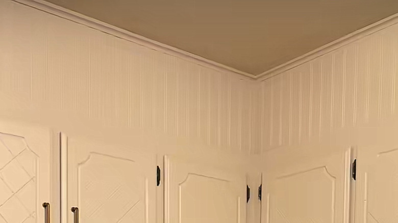 beadboard and trim on a kitchen soffit painted to match the cabinets