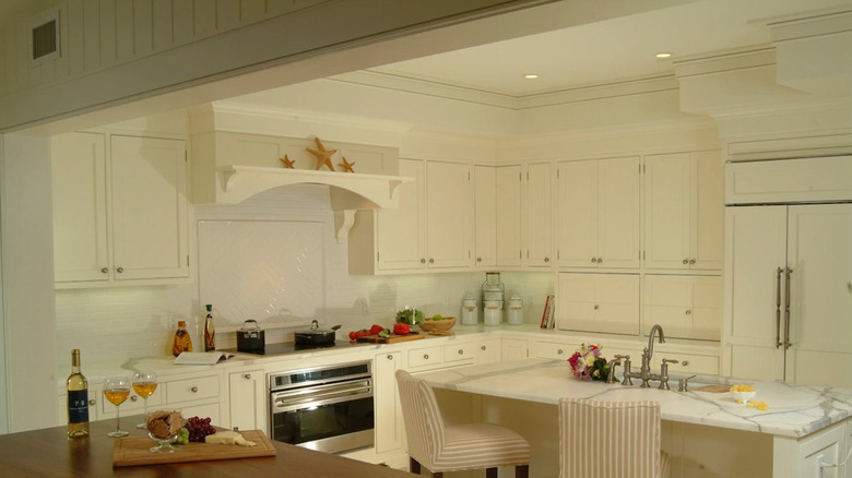 a kitchen with soffits extended around all sides of the room match the upper cabinets