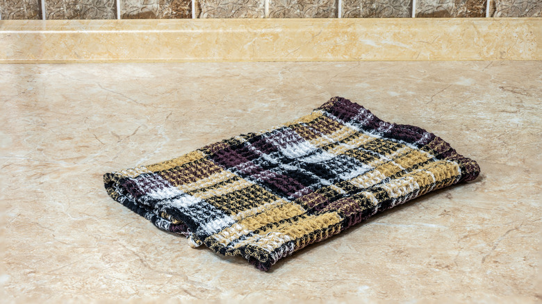 Checkered dish towel on a kitchen counter