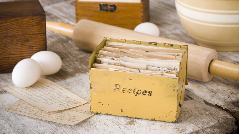 An antique recipe box on a wooden table.