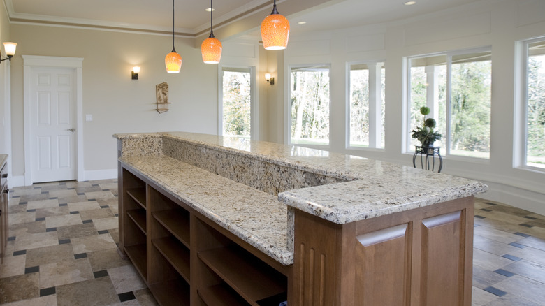 A split-level kitchen island with granite countertops.
