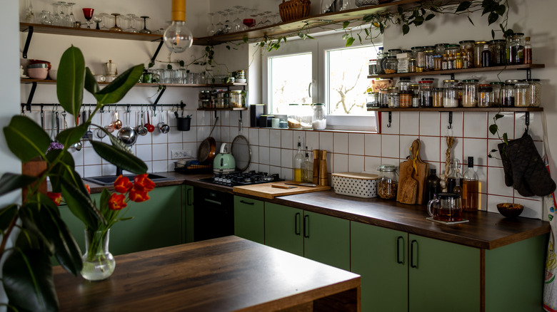 A rustic kitchen with avocado green cabinets.