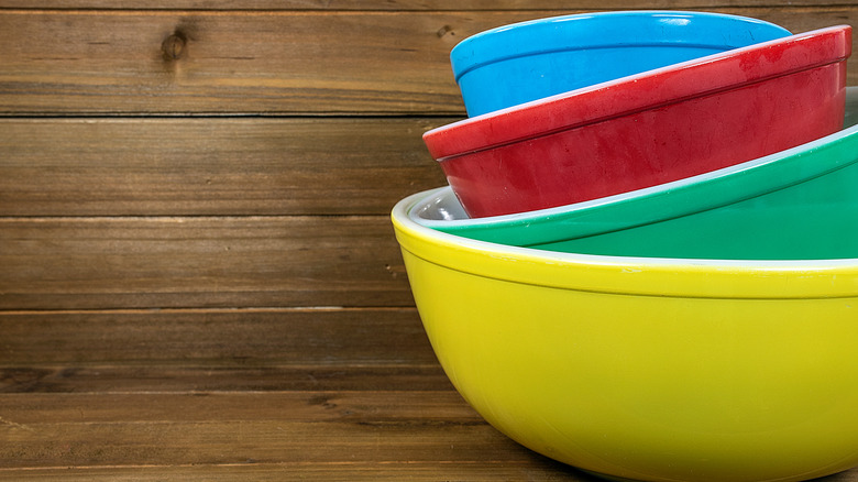 Colorful nesting mixing bowls on a wood surface