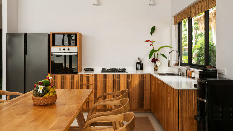 Kitchen with fluted warm wood cabinets