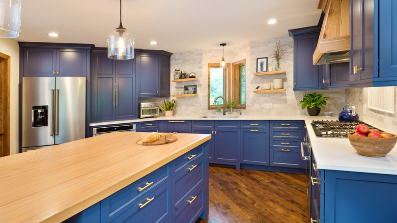 A kitchen with blue cabinetry.