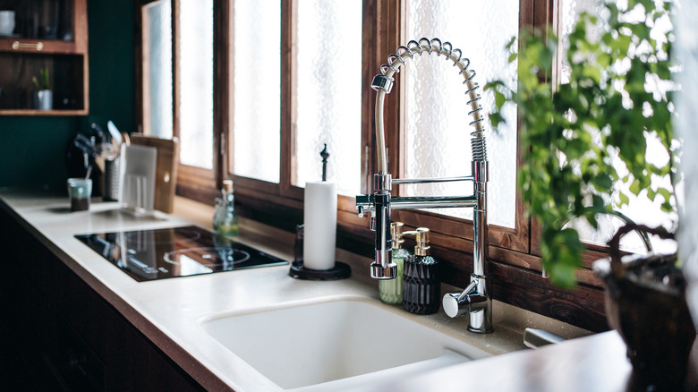 Interior of moody modern kitchen with double sink