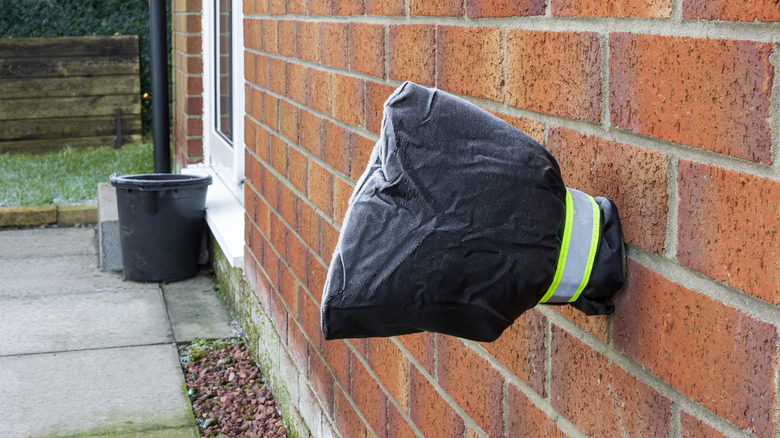The connecting point for an outdoor hose is bundled to protect it from freezing over the winter.