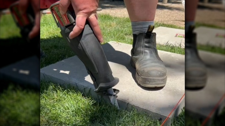 Person cutting into lawn using sawzall
