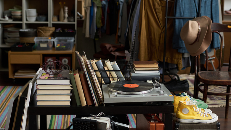 Books, a turntable, and other items on display at a thrift store
