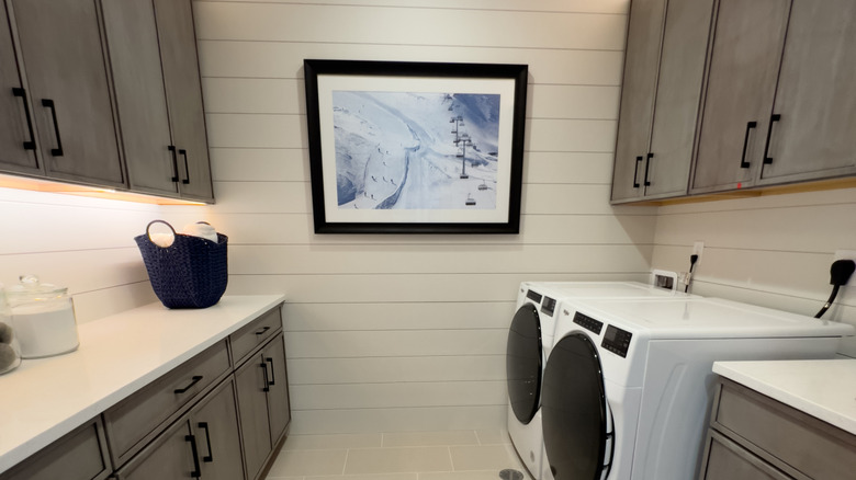 A laundry room featuring an art print
