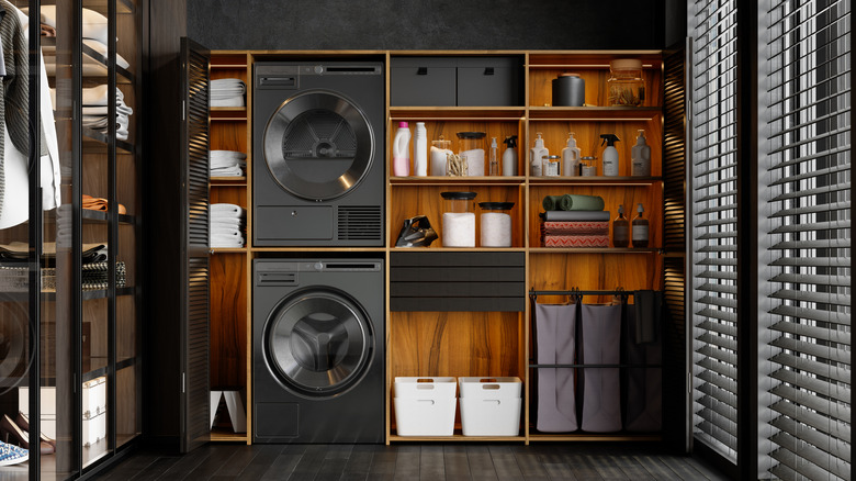 A modern luxurious laundry room with plenty of storage.