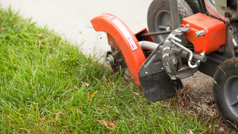 Close-up of a lawn-edging machine manicuring the edge of a lawn