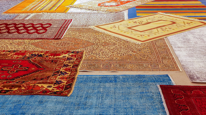 Various patterned rugs layered among each other