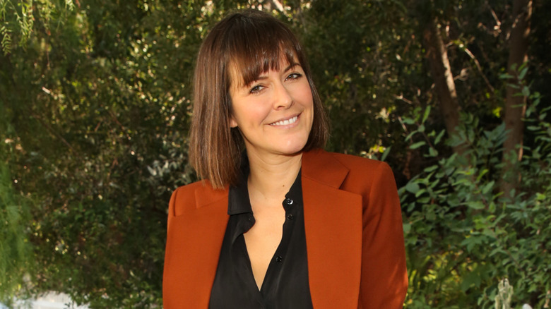 Leanne Ford smiling in front of greenery