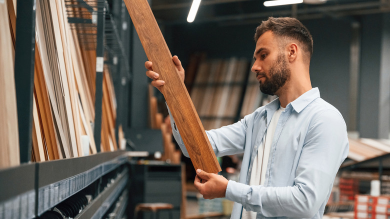 Man browsing parquet options at the store