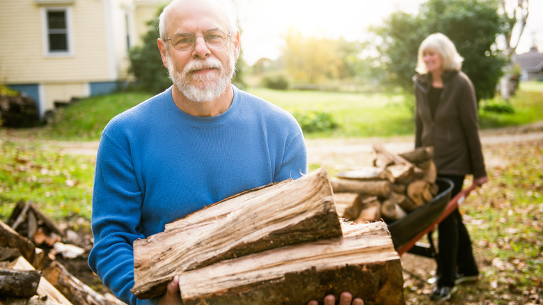 man carrying wood in garden