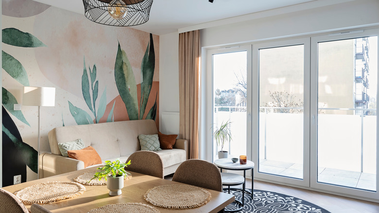Vibrant wallpaper behind sofa in a living room