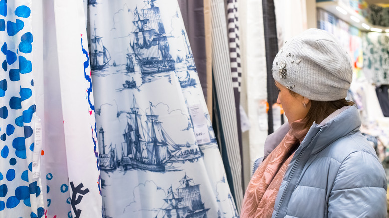 A person shopping for shower curtains
