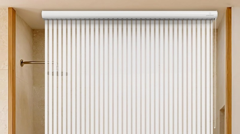 A Ceiling Mounted Rollup Bathroom Shower Curtain from Jakooz in a bathroom