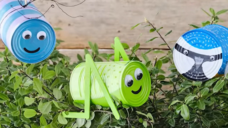 Garden creatures made of soup tin cans