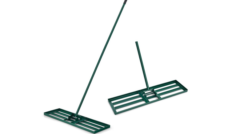A green metal lawn leveling rake tool