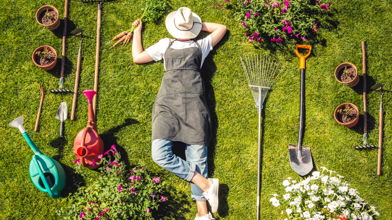 A gardener surrounded by tools
