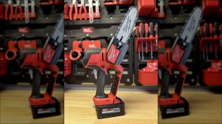 Milwaukee's M18 Lithium-Ion Brushless Cordless 8-inch Hatchet Pruning Saw on a wooden workbench