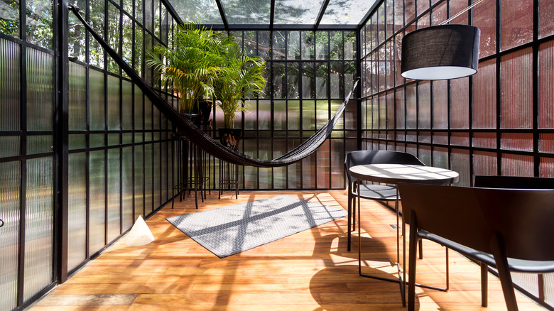 Sunroom with hammock and table
