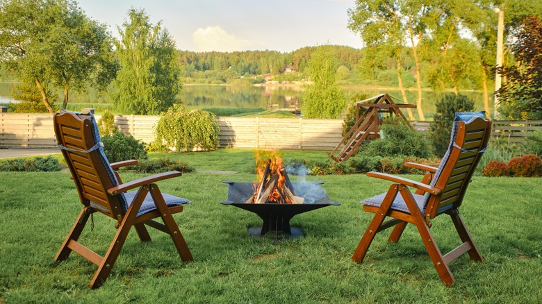 fireplace and wooden lawn chairs 