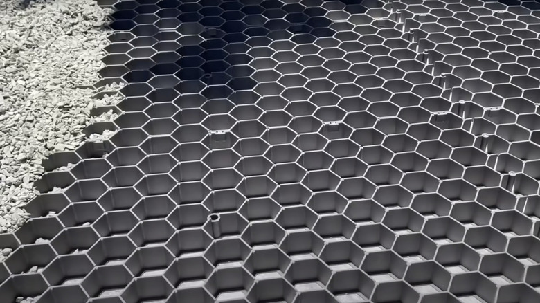 A gravel grid partially filled with stones