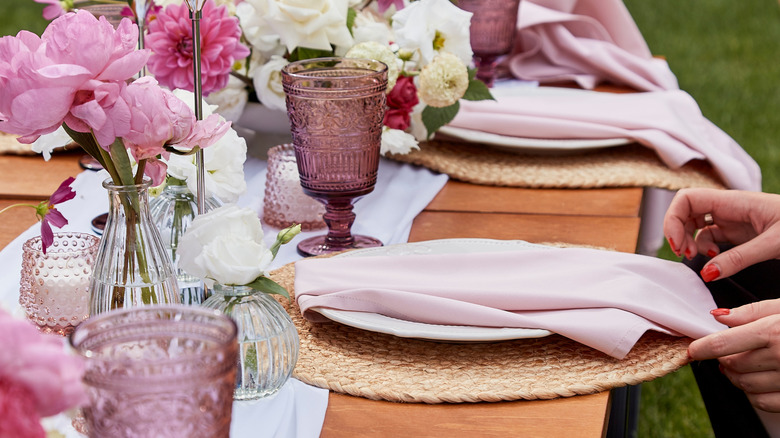 pink napkins that match pink flowers on tablescape
