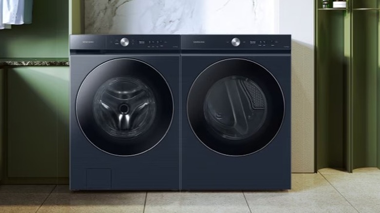 Navy blue washing machine and a dryer side-by-side in a laundry room