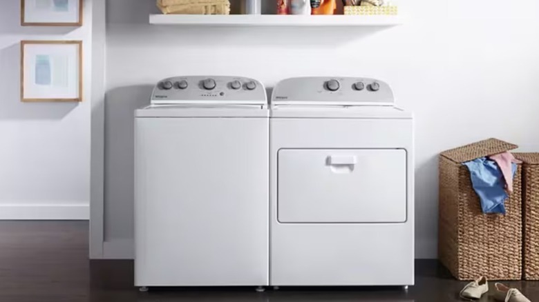 White washer and dryer side-by-side in a laundry room