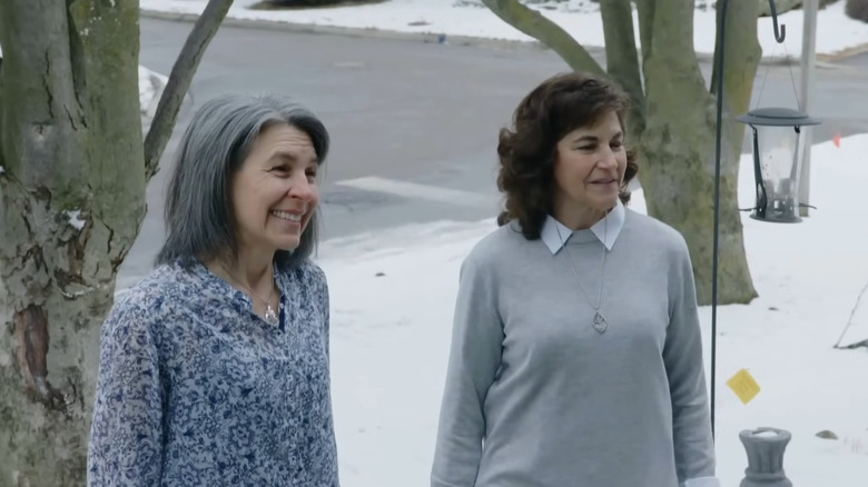Two women standing in a snowy yard