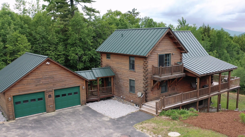 A two story log cabin near the woods