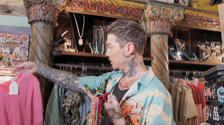 Bromstad holding up shirt