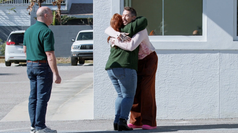 Bromstad hugging a client